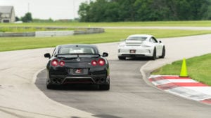 Nissan GT-R and Porsche 911 GT3 on a racetrack