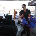 photo of adam olalde of xtreme xperience carrying gift donations at NOLA Motorsports Park