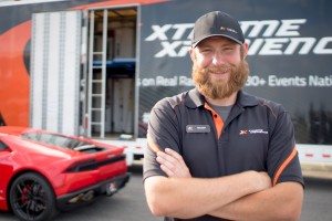 Photo of Chris in front of Xtreme Xperience Semi-truck and supercars
