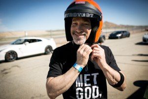 A smiling customer after driving a supercar at Willow Springs International Raceway