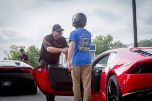 xtreme xperience instructor shakes hand of participant in Lamborghini Huracan