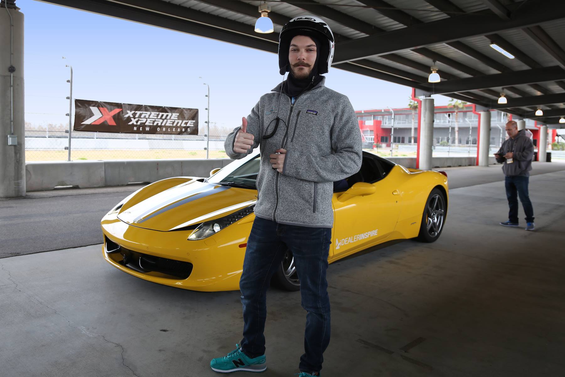 male participant thumb up with yellow ferrari 458 from dealer inspire event at NOLA
