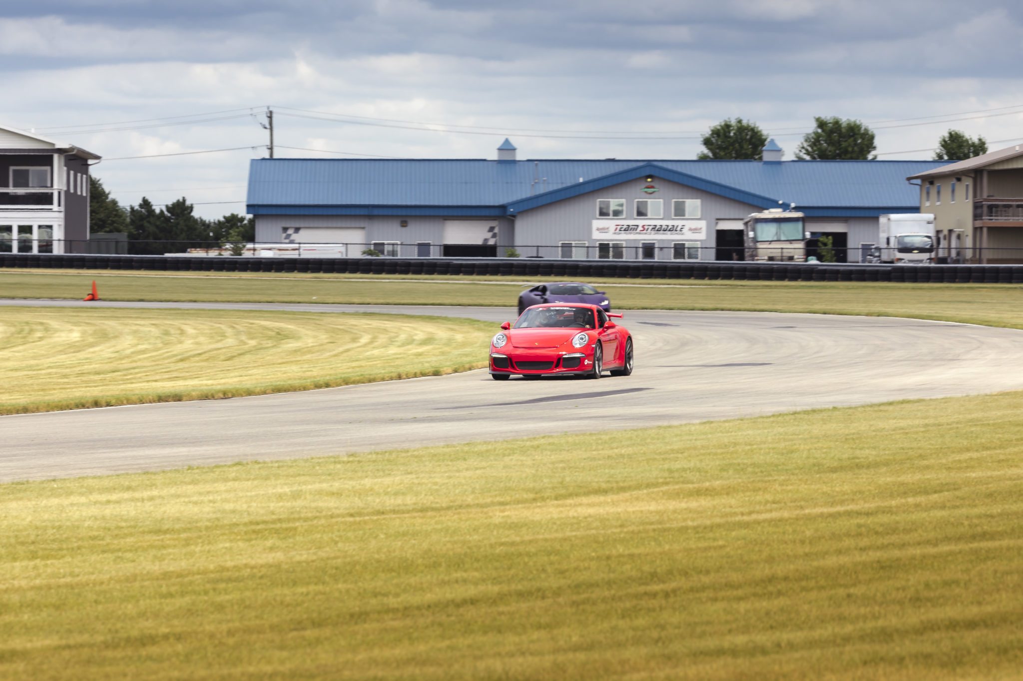 porsche gt3 and lamborghini huracan on track at autobahn country club with xtreme xperience