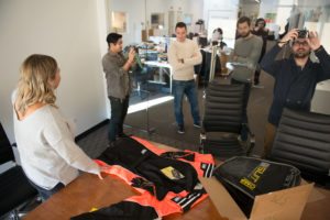 xx team looks at racing suit for supercar academy