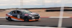 customers enjoying a high speed race track ride along in a chevy ss