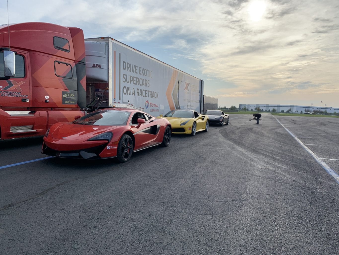 Supercars arriving at a racetrack