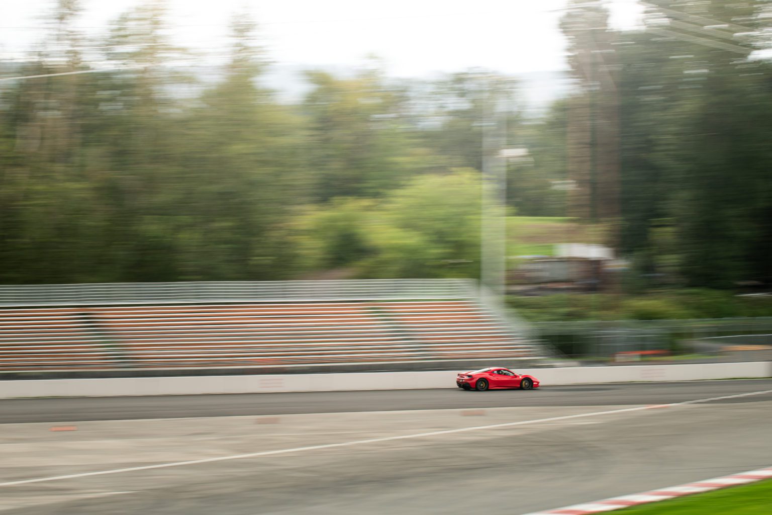 Xtreme Xperience's Ferrari 488 GTB driving on a racetrack. 