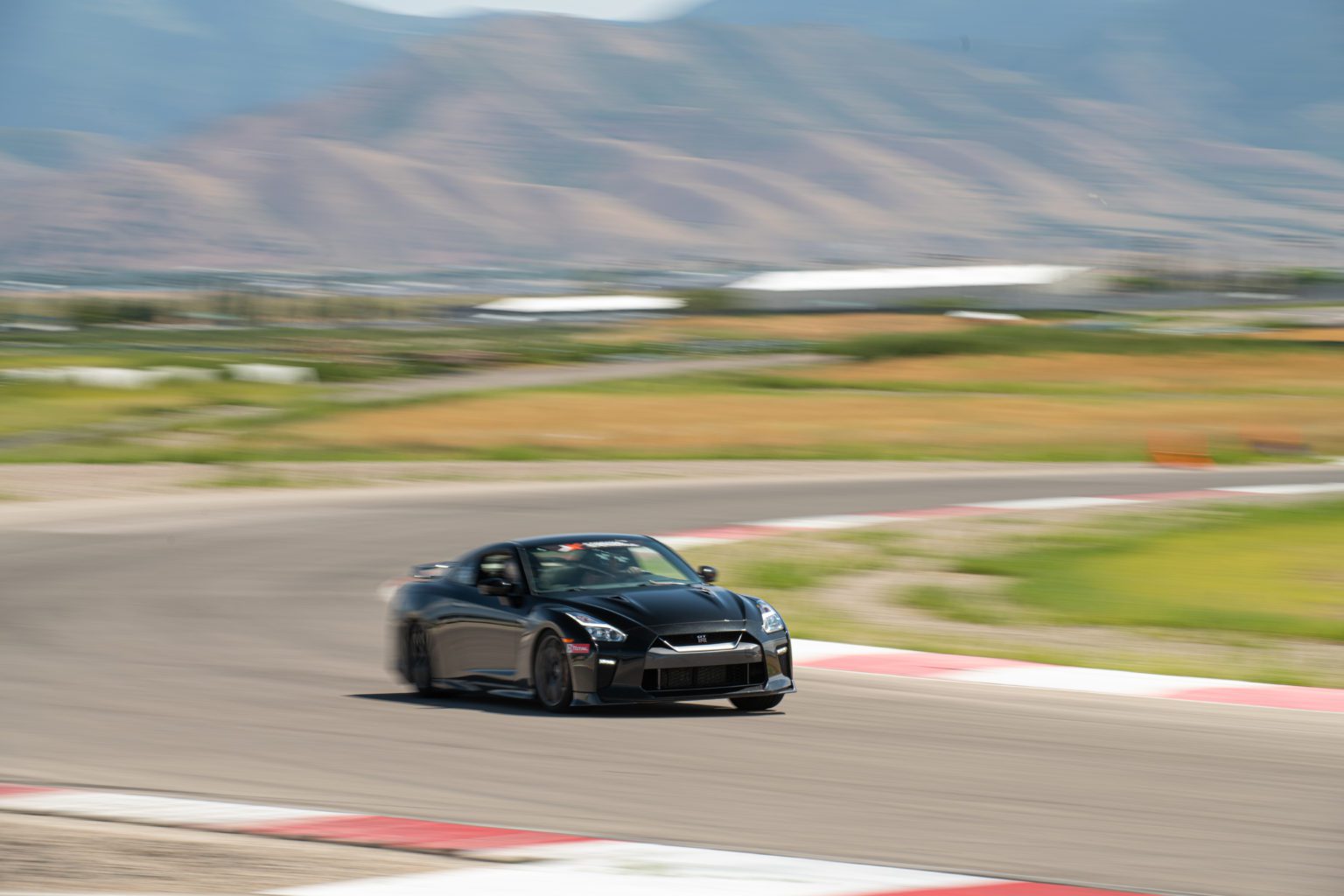 Xtreme Xperience's GTR driving on a racetrack.