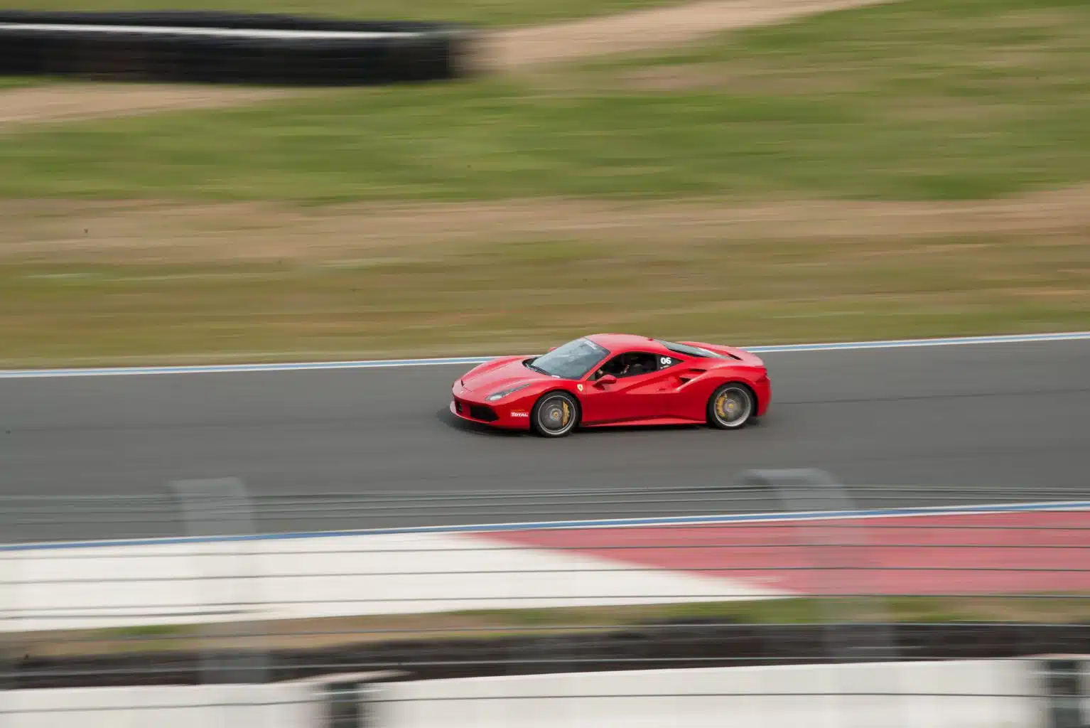 Xtreme Xperience's Ferrari 488 driving on a racetrack.